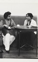 Photo of four individuals sat down on sofas