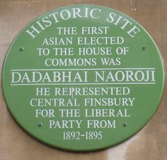 Green plaque commemorating the election of Dadabhai Naoroji to the House of Commons